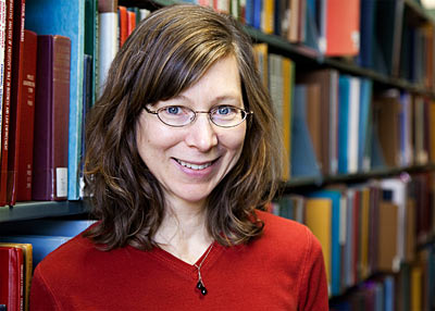 photo of woman with books behind