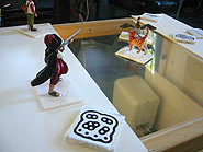 Photo of table with window in center and figurines on top